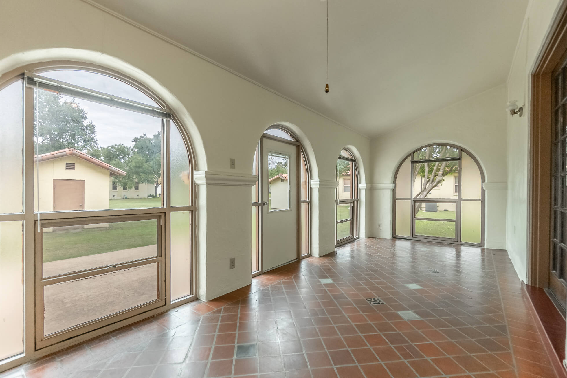 Large sunroom with tile flooring