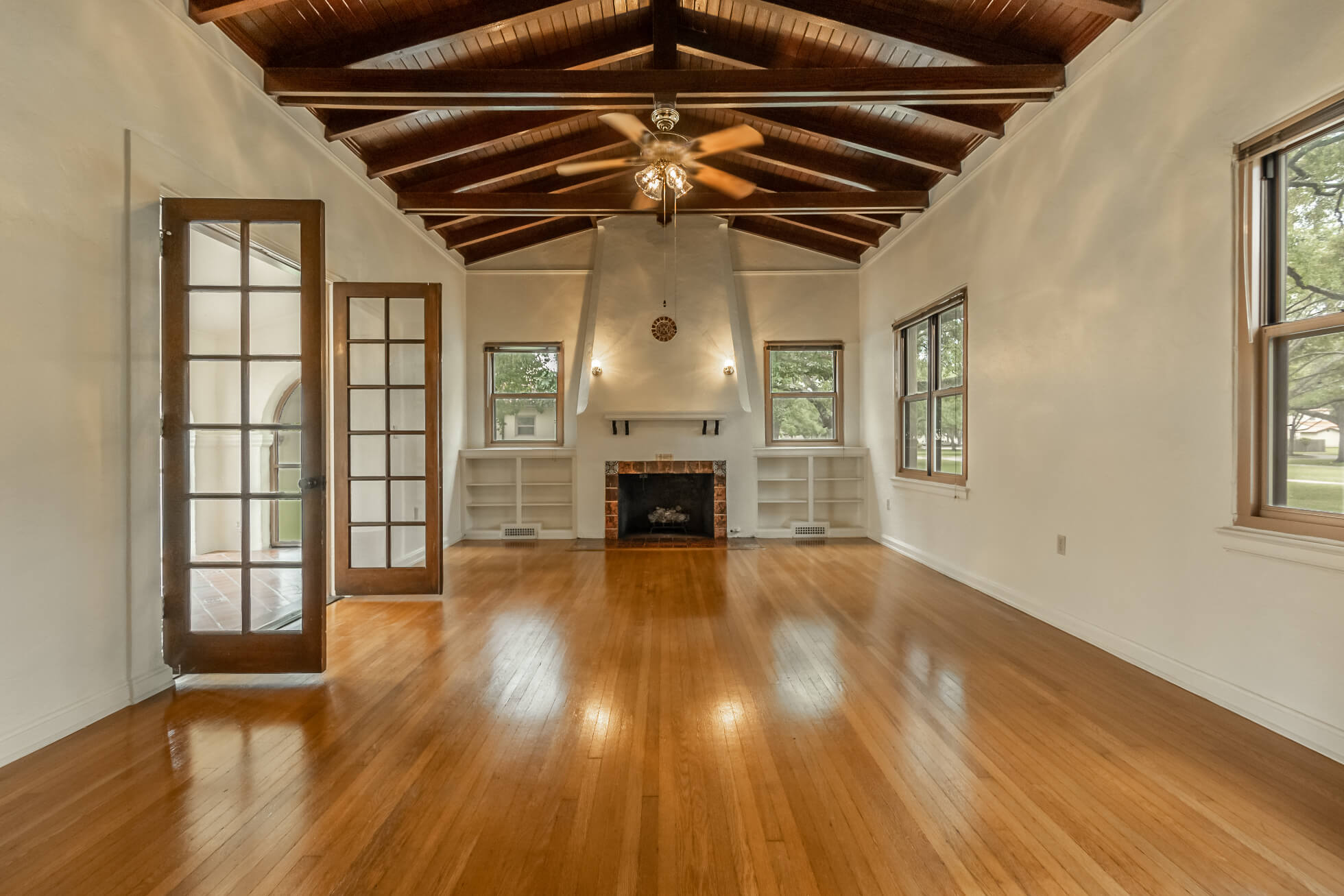 Large open living space with a fireplace and built-in shelving