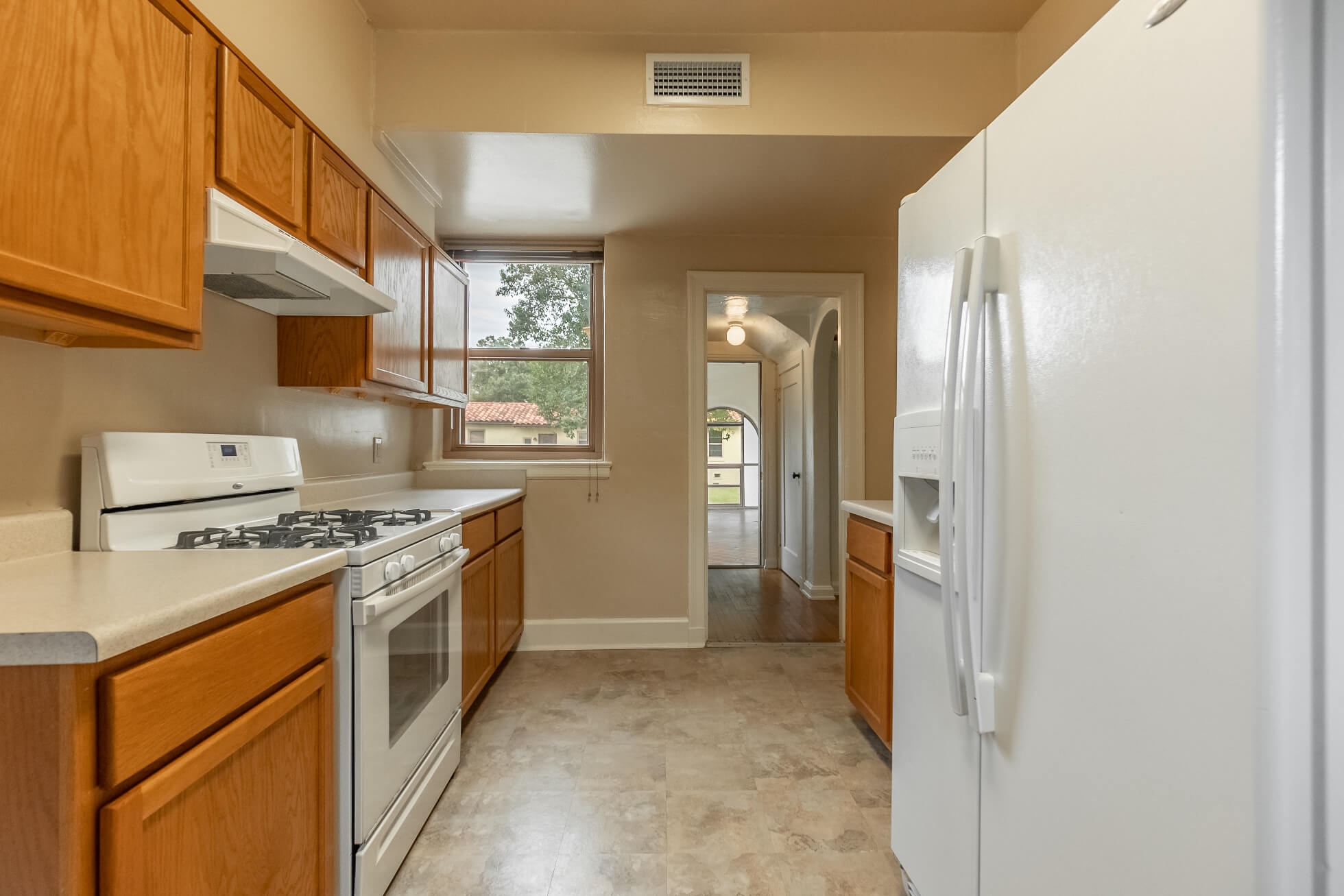 Kitchen area with stove and fridge